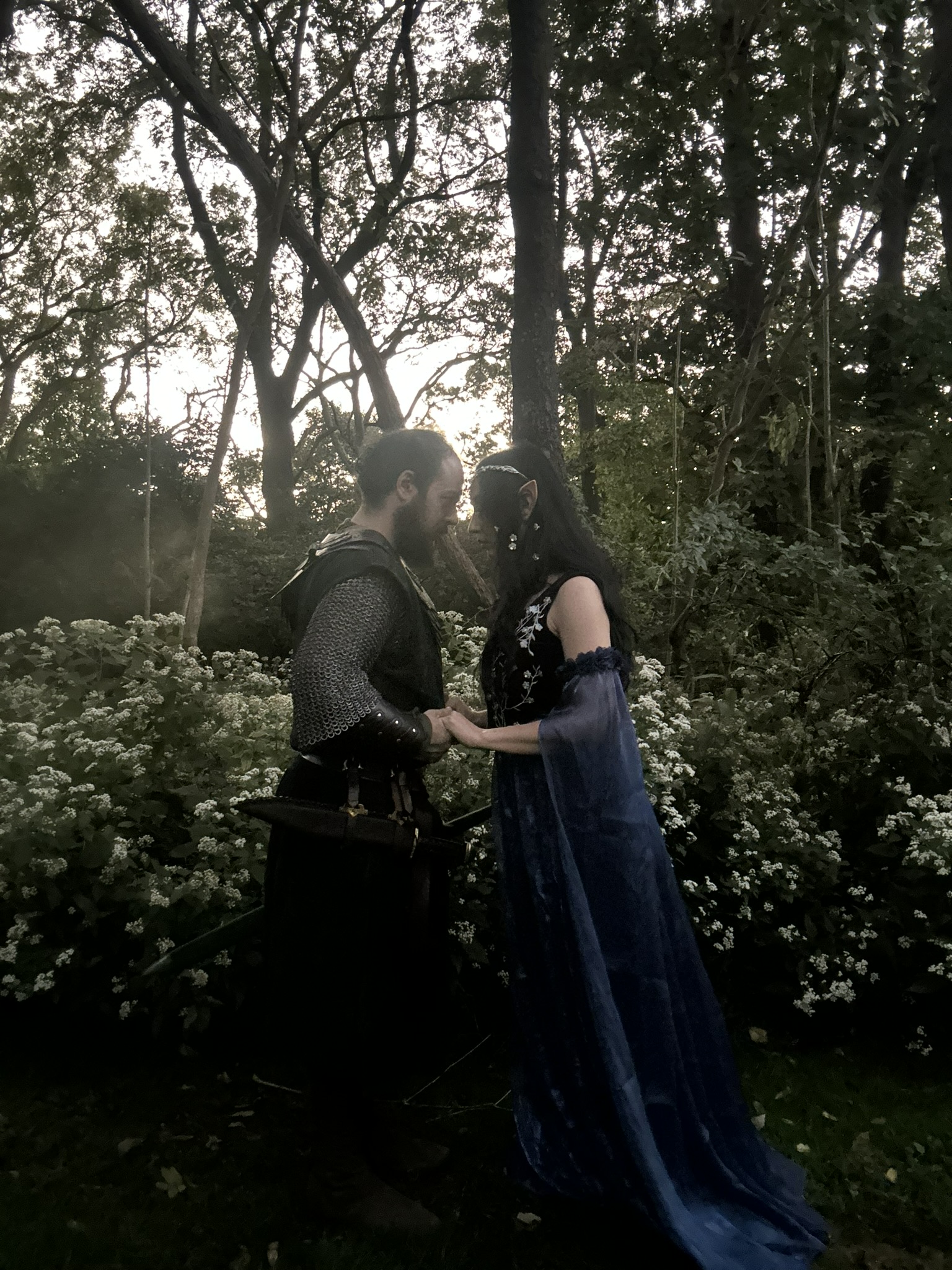 Beren and Luthien stand together with their foreheads pressed together